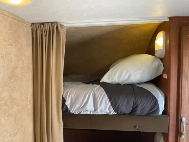 Top Bunk setup, delivered, ready for exploring of RV Rental trailer Blue Jay Getaway located at Kindlewood Camping in the Berkshires of Western Massachusetts