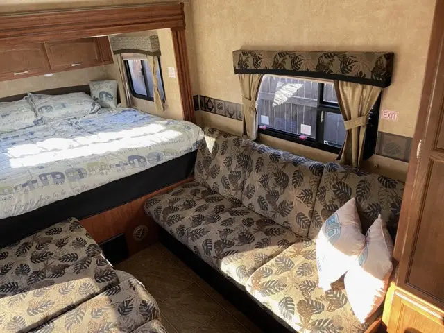 Couch setup camping service of RV Rental trailer Blue Jay Getaway located at Kindlewood Camping in the Berkshires of Western Massachusetts