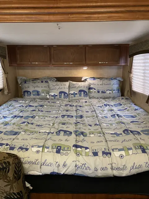 King size bed set up for you of RV Rental trailer Blue Jay Getaway located at Kindlewood Camping in the Berkshires of Western Massachusetts